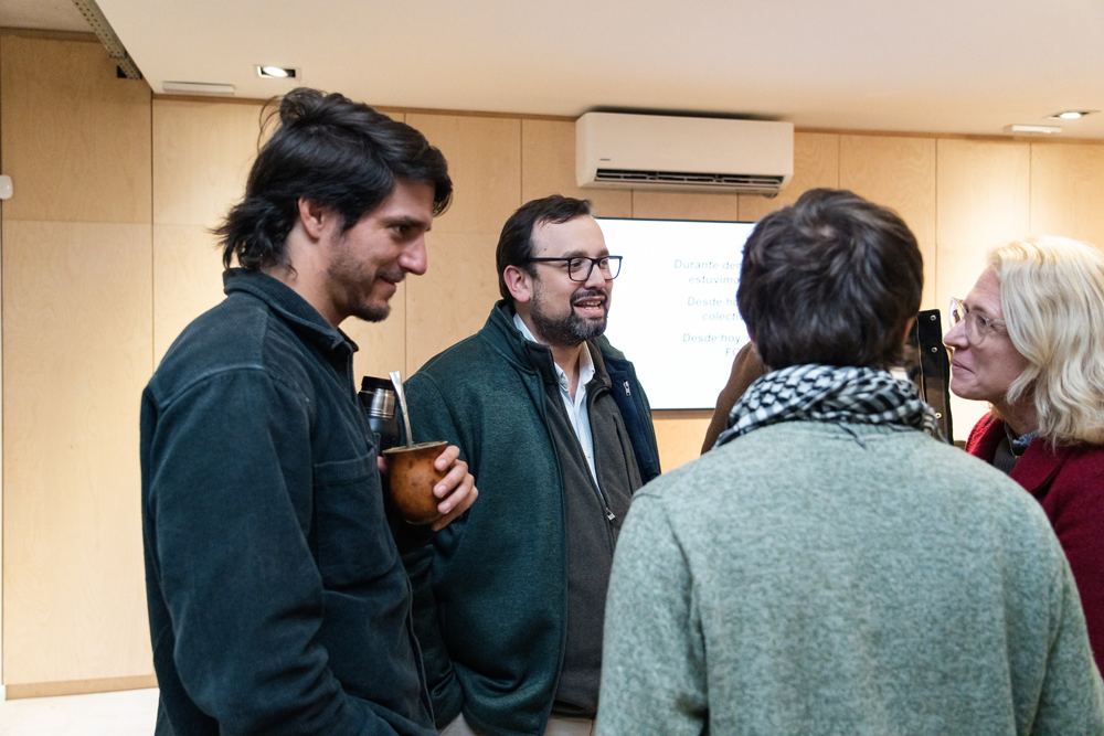 Asistentes conversan después del acto, mate en mano